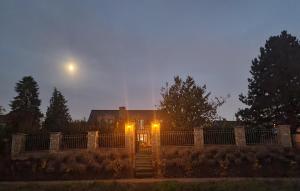 a house with the moon in the sky behind it at Schönste Lage am Rhein in unmittelbarer Stadtnähe, B & B in Cologne