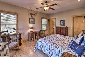 a bedroom with a bed and a table and chairs at The Captains Quarters in Rogers with Covered Porch! in Rogers
