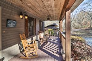 a porch of a house with rocking chairs on it at The Captains Quarters in Rogers with Covered Porch! in Rogers