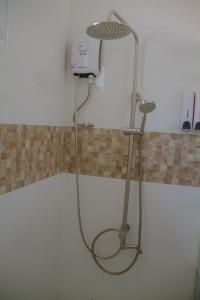 a shower in the corner of a bathroom at La Playa Estrella Beach Resort in Bantayan Island