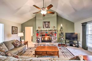a living room with a fireplace and a christmas tree at Blairsville Home with Deck and Stunning Mountain Views in Hood