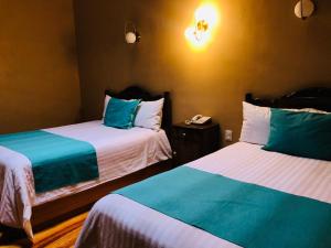 Postel nebo postele na pokoji v ubytování Hotel Boutique Casa de las Manrique