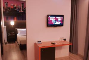 
a television is on in a room at Athens City Hotel in Athens
