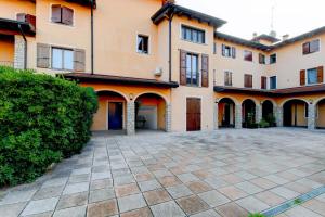 a large house with a courtyard in front of it at In Love in Montichiari