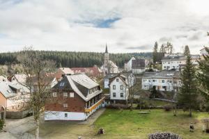 a small town with a church in the background at Ferienwohnung Urs in Schönwald