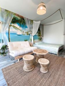 a living room with a couch and two tables at Happyhosts Beach House studio in Hanko