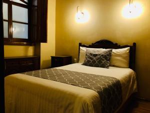 Postel nebo postele na pokoji v ubytování Hotel Boutique Casa de las Manrique