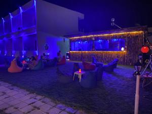 a group of people sitting outside of a building at night at Aroma Butik Hotel in Kızılot