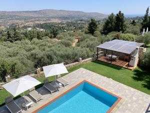 an external view of a villa with a swimming pool at Villa Avra Vrisses Crete in Alikampos