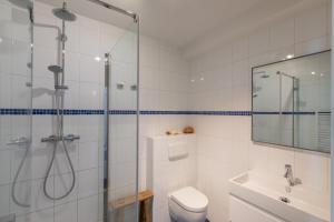 a bathroom with a shower and a toilet and a sink at Welcome in - Borne 56a, Zoutelande in Zoutelande +25 photos