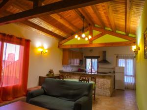 a living room with a couch and a kitchen at Casarural Vallecillo in Vallecillo