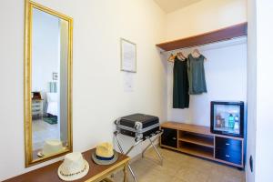 a room with a mirror and a table with hats at Sun&Sardinia in Monserrato