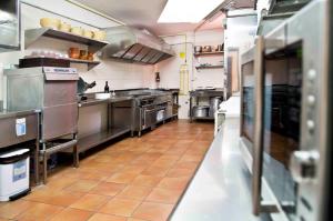 a large commercial kitchen with stainless steel appliances at Albergue de Bolico in Buenavista del Norte