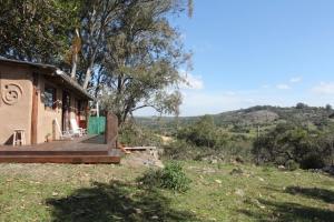 a house on a hill with a view of a field at Odisea in Villa Serrana