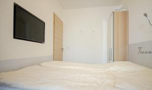 Postel nebo postele na pokoji v ubytování Vier Jahreszeiten Haus 6 Whg 08