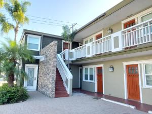 a house with a staircase and palm trees at Coronado Island Inn in San Diego