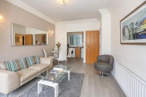 a living room with a couch and a table at IFSC Townhouse Apartments in Dublin