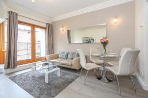 a living room with a couch and a table at IFSC Townhouse Apartments in Dublin