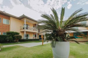 a palm tree in front of a building at Vistabela Resort & Spa in São Sebastião