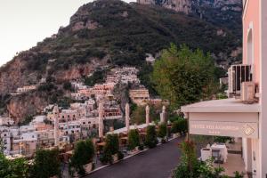 a view of a city with a mountain in the background at Hotel Villa Gabrisa in Positano