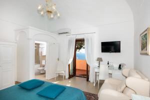 a living room with a bed and a dining room at Hotel Villa Gabrisa in Positano