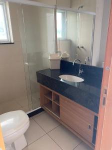 a bathroom with a sink and a toilet and a mirror at Hotel Mont Blanc Diamond Flat in Nova Iguaçu