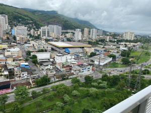 a view of a city with buildings and mountains at Apart Hotel Diamond Flat 2 Quartos in Nova Iguaçu