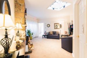 a living room with a couch and a window at Newton Villa in Brampton