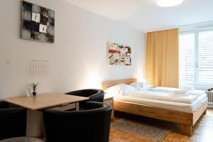 a bedroom with a bed and a table and chairs at Central living - Stephansdom Apartments in Vienna