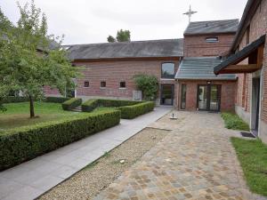 a brick building with a walkway in front of it at Beautiful former monastery completely renovated in Sint-Truiden