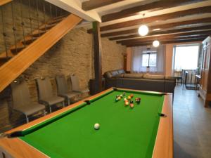 a billiard table in a room with chairs at Pretty cottage with billart and 2 bathrooms in Marfontaine