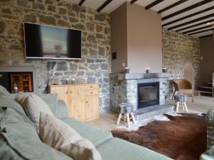 a living room with a couch and a fireplace at Quaint Holiday Home in Fala n in Falaën