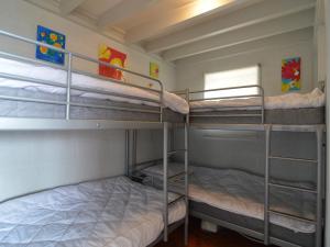 a room with two bunk beds and a window at Holiday home with an Ardennian style, boasting a large terrace, located in Coo in Stavelot