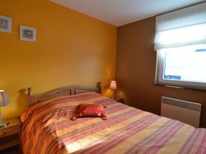 a bedroom with a bed with a stuffed animal on it at Detached house with breathtaking views in Malmedy