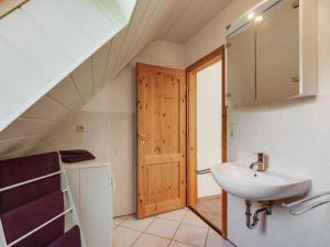 a bathroom with a sink and a staircase in a house at Ruhiger Aufenthalt in der Naehe von Rostock in Kritzmow +32 photos