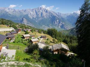 a village on a hill with mountains in the background at Top chalet with unobstructed view inthe ski resort in La Tzoumaz