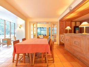 a kitchen and dining room with a table and chairs at Lavish Holiday Home in Fauvillers with Garden in Fauvillers