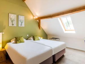 two beds in a room with green walls at Historic Farmhouse in the middle of polder landscape Damme in Oedelem