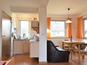 a kitchen with a couch and a table in a room at Ferienhaus in Rerik nahe Ostseestrand in Rerik