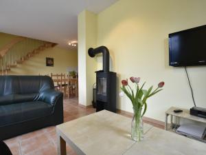 a living room with a vase of flowers on a table at Cozy 5-bedroom Holiday Home in Zierow with Garden in Zierow