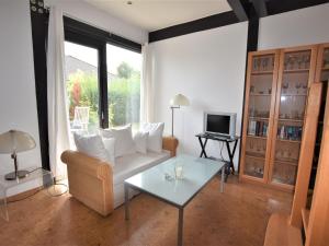 a living room with a white couch and a glass table at Beautiful villa in La Roche-en-Ardenne near the center in Stove