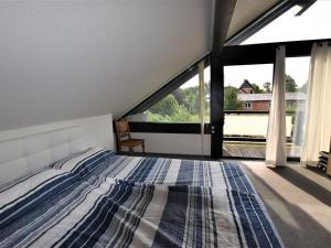 a bedroom with a bed and a large window at Beautiful villa in La Roche-en-Ardenne near the center in Stove