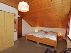 a bedroom with a bed with a wooden ceiling at Apartment in Armsfeld with heated outdoor pool in Bergfreiheit