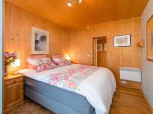 1 dormitorio con 1 cama en una pared de madera en Beautiful holiday home with garden, en Eichenborn