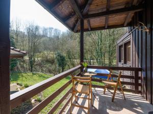 un porche con 2 sillas y una mesa. en Beautiful holiday home with garden, en Eichenborn