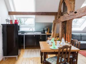 a kitchen and dining room with a wooden table at Vintage Apartment with Garden in Schleiden