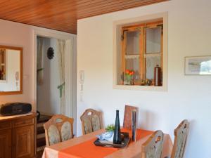 a dining room with a table and chairs and a window at Serene Apartment in Meschede with Balcony in Grevenstein