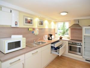 a kitchen with white cabinets and a sink at Apartment in L wensen with private terrace in Bad Pyrmont