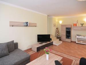 a living room with a couch and a tv at Apartment in L wensen with private terrace in Bad Pyrmont