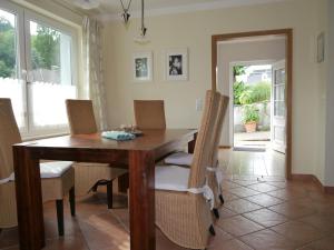 a dining room with a wooden table and chairs at Apartment in L wensen with private terrace in Bad Pyrmont